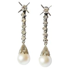 These retro-style earrings from the 1950-1955 era are crafted in platinum 950 and feature diamonds and pearls. They have a combined weight of 7.90 grams. The earrings are adorned with brilliant-cut diamonds in various sizes: 10 units of 0.80 carats, 2 units of 0.15 carats, and 8 units of 0.08 carats, totaling 1.18 carats. The diamonds have VS-SI clarity and H color. There are also 2 pearls, each measuring 7.9 mm in diameter. The gemstones are set in claw settings, and the earrings have a pressure system for closure. **IN STOCK** Characteristics: Material: Platinum 950 Diamonds: Brilliant Cut, Total Weight: 1.18 ct, VS-SI Clarity, H Color Pearls: 2 units, 7.9 mm each Weight: 7.90 grams Setting: Claw Closure: Pressure System Diamonds And Pearls, Platinum Earrings, Style Earrings, Brilliant Cut Diamond, Style Retro, Retro Fashion, Platinum, Jewelry Earrings, Drop Earrings