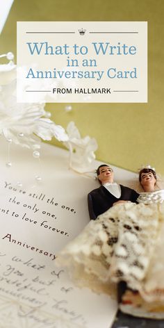 two figurines sitting on top of an anniversary card with the words, what to write in an anniversary card from halmark