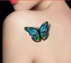 a woman's back with a butterfly tattoo on it