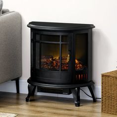 an electric fireplace in a living room next to a couch and chair with a wicker basket on the floor