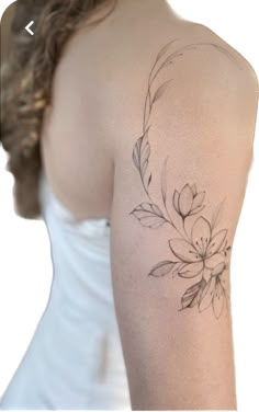 a woman with a flower tattoo on her arm