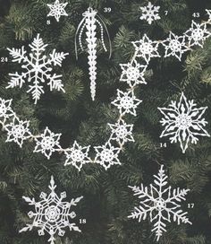 snowflakes are hanging on the christmas tree and numbers have been added to them