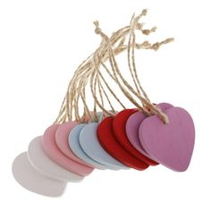 heart shaped wooden tags hanging from string on white background