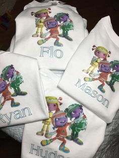 four personalized onesuits with cartoon characters on them