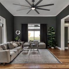 a living room filled with furniture and a ceiling fan in the middle of the room