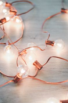 some lights that are sitting on top of a wooden table with words written below them