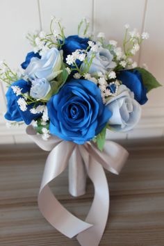 a bouquet of blue roses and white flowers