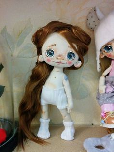 two dolls are sitting next to each other