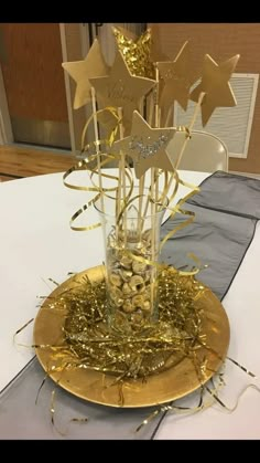 a gold plate topped with stars on top of a table