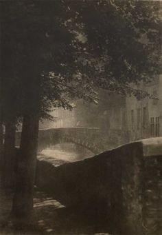 an old black and white photo of a bridge