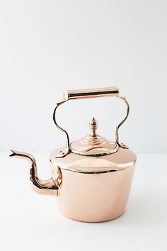 a pink tea pot with a handle on the side and a silver lid is sitting in front of a white background