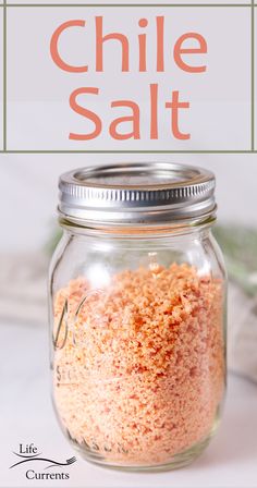 a mason jar filled with chili salt sitting on top of a table