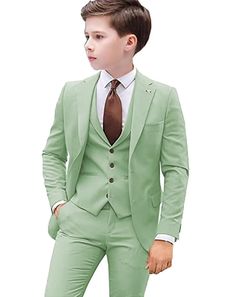 a young boy in a green suit and tie