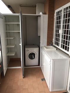 a washer and dryer in a small room with open doors to the outside