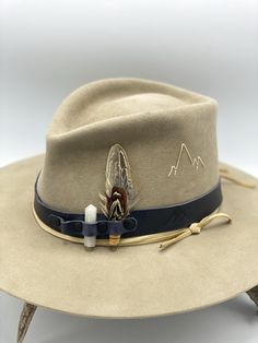 Leather Hat Band Adjustable closure to fit any hat size Pockets hold stones, feathers, and other accessories Embossed Mountain Logo