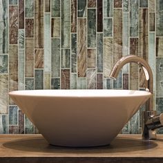 a white bowl sink sitting on top of a wooden counter