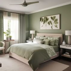 a bedroom decorated in green and white with a bed, chair, table, lamps and pictures on the wall