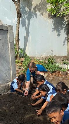 a group of children are in the dirt