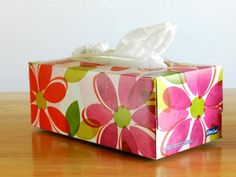 a tissue box sitting on top of a wooden table