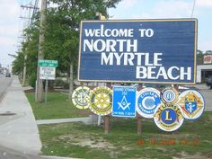 a welcome sign to north myrtle beach is displayed on the side of the road