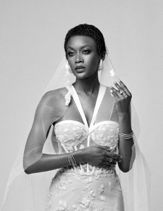 a black and white photo of a woman in a wedding dress