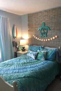 a bed room with a neatly made bed and a string of lights on the wall