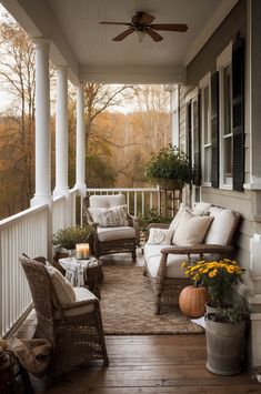 a porch with wicker furniture and fall decor