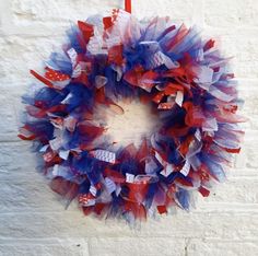 a red, white and blue wreath hanging on the wall