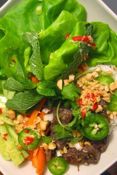 a white plate topped with lettuce and vegetables