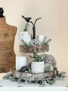 a three tiered tray with candles and ornaments