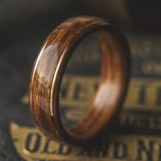 a wooden ring sitting on top of an old book