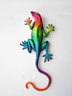 a colorful gecko sitting on top of a white surface