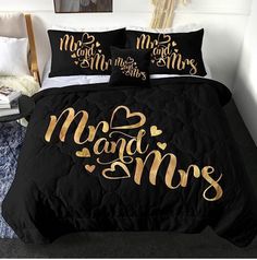 a bed with black and gold comforter, two matching pillow cases that say mr and mrs