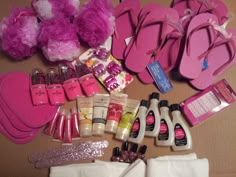 the contents of a barbie doll laid out on top of a wooden table with pink shoes and other items