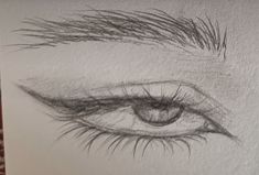 a pencil drawing of an eye with long lashes on it's side and the bottom part of its iris