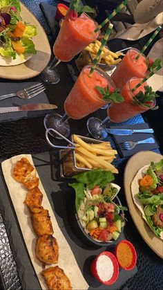 a table topped with lots of different types of food and drinks on top of plates