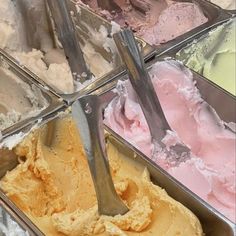 several scoops of ice cream in metal containers