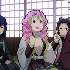 three anime characters sitting on the floor with one holding a cell phone in her hand