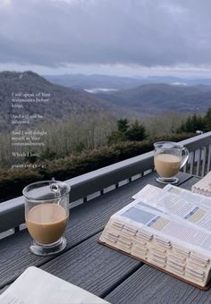 two glasses of coffee and an open book on a deck