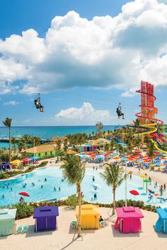 the water park is full of people and colorful slides