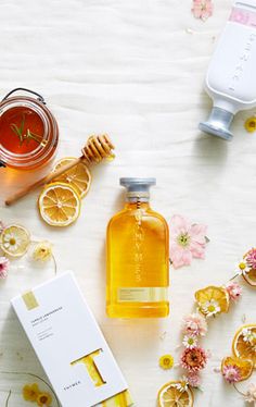 an assortment of personal care items including honey, lemons and other things on a table