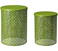 two green metal canisters sitting next to each other on a white background,