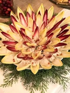 an arrangement of flowers is displayed on a table