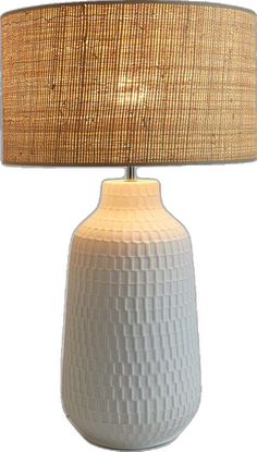 a white table lamp with a beige shade on it's base and a light bulb