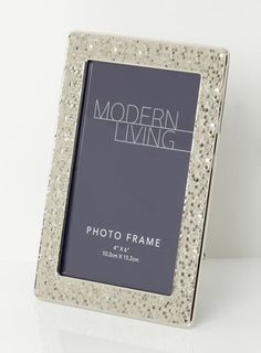 a silver photo frame sitting on top of a table