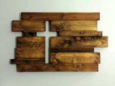 a cross made out of wooden planks on a wall