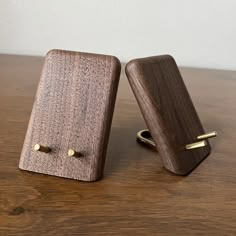 two wooden cufflinks sitting on top of a wooden table