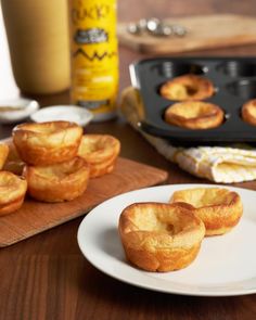 small pastries on a white plate next to a muffin tin and baking tray