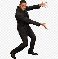 a man in a suit is dancing with his hands out