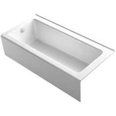 a white bath tub sitting on top of a white counter next to a faucet